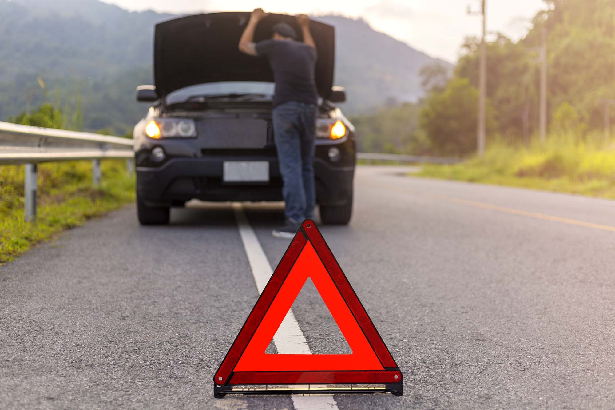 Breakdown Recovery sign with man looking at car engine