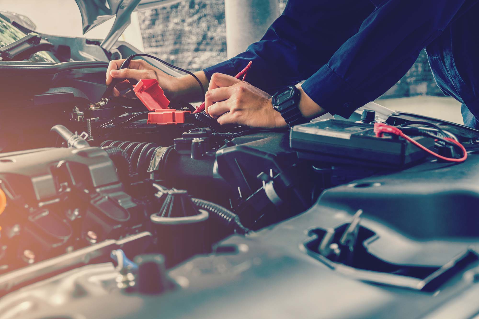 Mechanic checking car battery