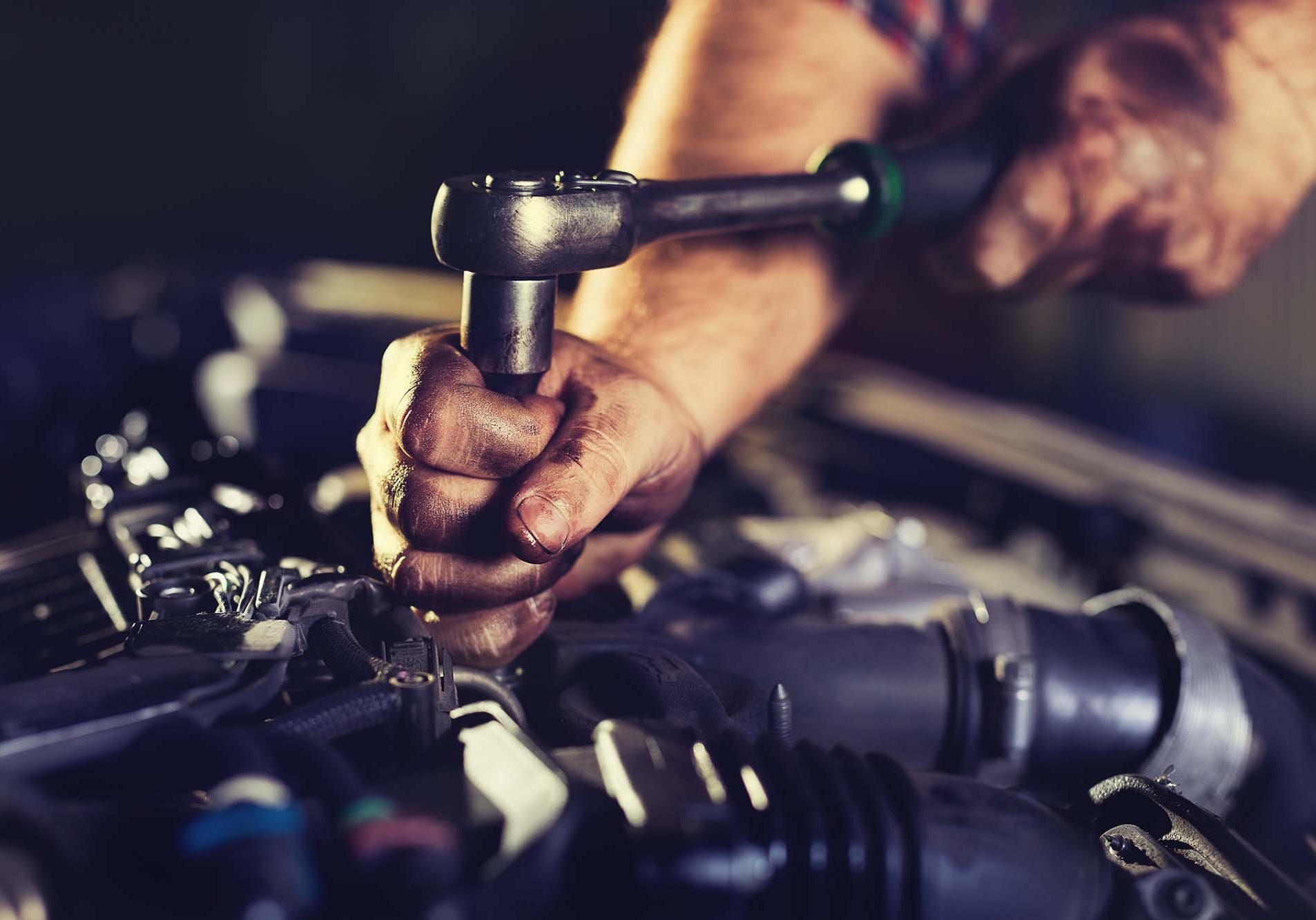 Mechanic with dirt hands servicing car